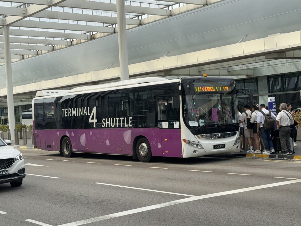 an airport shuttle bus outside a terminal