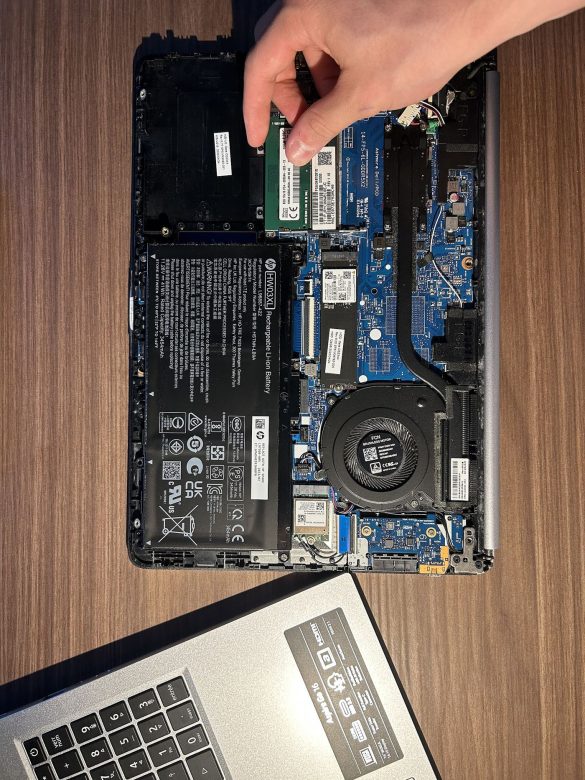 A laptop being repaired on a workbench